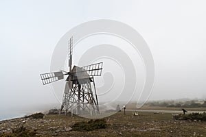 Old windmill in a misty landscape