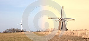 Old windmill and modern turbine in the Netherlands - Old meets new