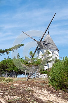 Old windmill on sand dunes in island of Noirmoutier Vendee France