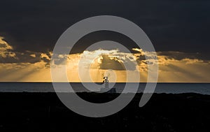 Old windmill silhouette at sunrise