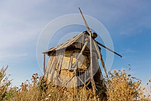 An old windmill standing in a field.