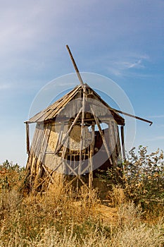 An old windmill standing in a field.
