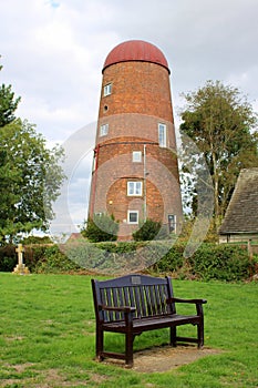 Old windmill tower and park bench