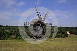 Old windmill. Ukrainian mill of the nineteenth century. Summer landscape, sunshine. Village Pirogovo