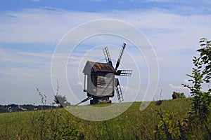 Old windmill. Ukrainian mill of the nineteenth century. Summer landscape, sunshine. Village Pirogovo