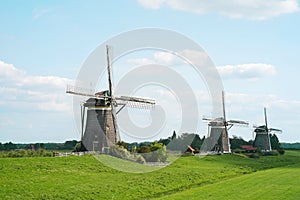 Old windmills against the blue sky