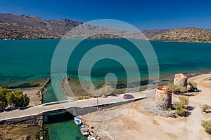 Old windmills and canal on a narrow causeway and site of an ancient Minoan city