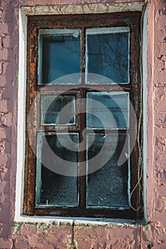 Old window of an abandoned house in the village