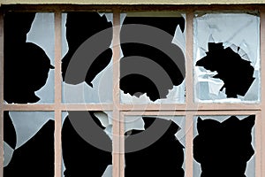 Old window with broken panes of glass