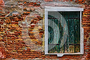 an old window in a broken brick wall