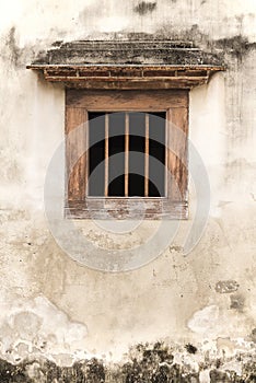 Old window on cement wall.