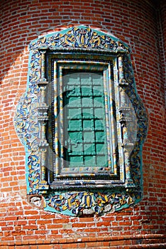 Old window decorated by colorful tails.