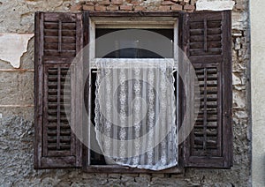 old window with embroidered curtain, Pula, Croatia