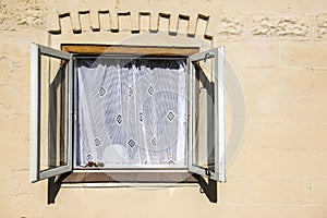Old window frame with white old style curtain