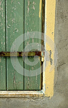 The old window with green shutter and wall