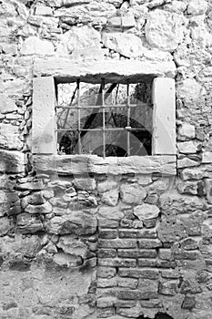 Old window grille of a ruined castle