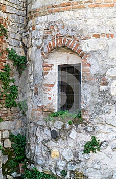 Old window grille of a ruined castle