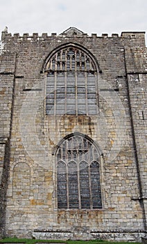 Old window on the historic medieval cartmel priory in cumbria now the parish church of st micheal and mary