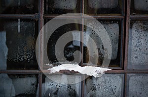 Old window with hoarfrost and snow