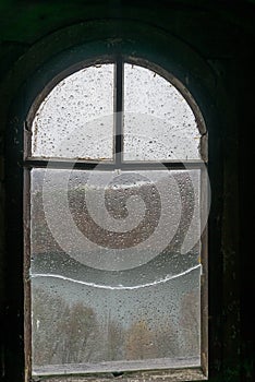 Old window of medieval castle with wooden frame, broken glass