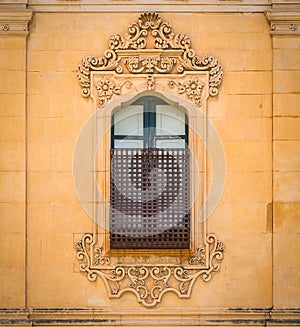 Old window in Noto with baroque decorations. Sicily, Italy. photo