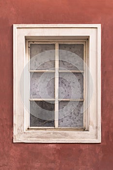 Old window onred stucco wall