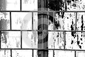 Old window painted white paint behind a rusty bars, black and white