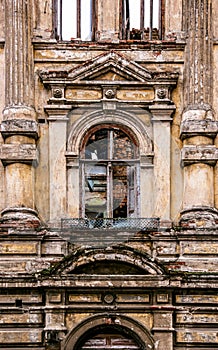 An old window in ruined mansion. Facade of the old burnt house