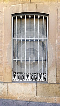 Old window with security bars, steel grill