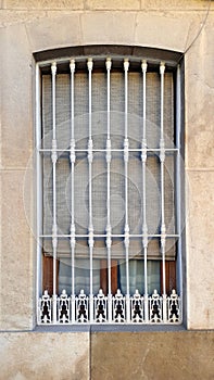 Old window with security bars, steel grill. Stone suround and bl