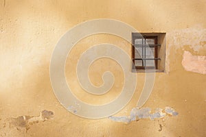 Old window on an stone wall of a fortress in Spain,