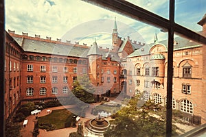 Old window view on green courtyard of Copenhagen City Hall, built in 1905 in Denmark. National Romantic style