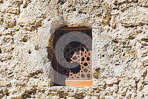 An old window on the wall of an old fortress