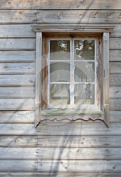 The old window in the wooden gouse wall
