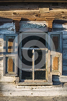 Old window of wooden house in Chernobyl exclusion zone
