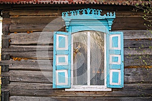 Old window of wooden house in Chernobyl exclusion zone