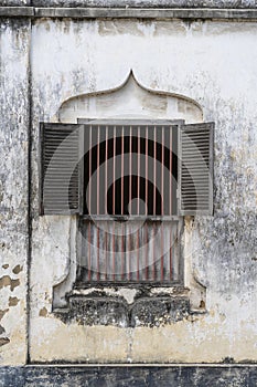 Old window with wooden shutters on white stucco wall in Stone Town on island Zanzibar, Tanzania, Africa