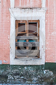 Old Windows with broken glass and broken frames in the old house.