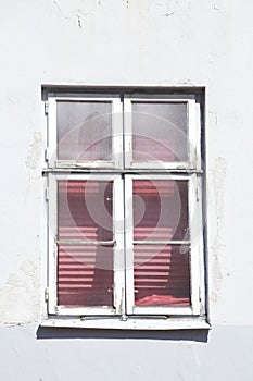 Old windows with closed shutters