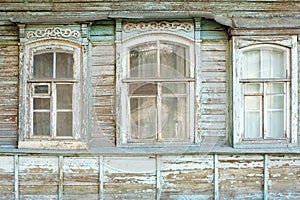 Old windows of obsolete wooden traditional Russian house.