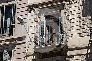 Old windows of the one of the historical buildings in center of Barcelona. Spain