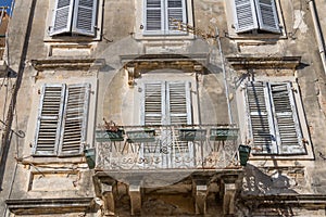 Old windows with wood jalousie and flowers