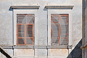 Old windows with wooden shutters from the sun