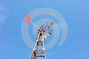 An old windpump against the blue sky