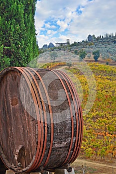 Old wine barrel in Tuscany autumn landscape