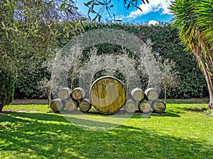 Old wine barrels stacked as a garden decoration in the garden