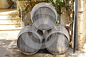 Old wine barrels stand on the street near a house in the city of Zichron Yaakov.