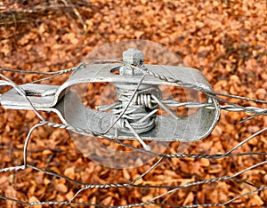 Old wire tensioner of a wire fence in closeup