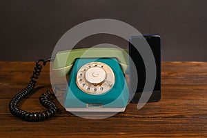 an old wired phone and a smartphone