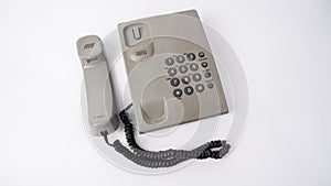 Old wired phone on white background in hold position